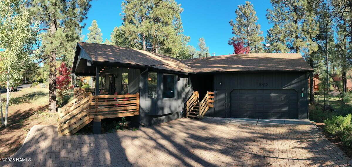 865 Caribou Road Munds Park, AZ 86017 - Photo 21 of 24 a front view of a house with a garden
