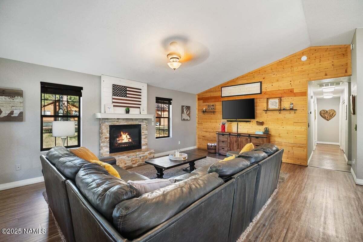 865 Caribou Road Munds Park, AZ 86017 - Photo 3 of 24 a living room with furniture and a fireplace