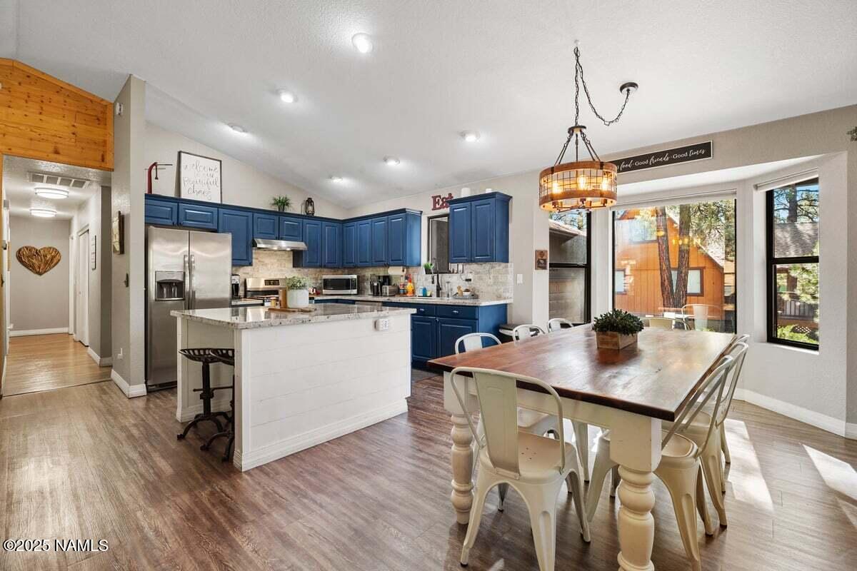 865 Caribou Road Munds Park, AZ 86017 - Photo 5 of 24 a kitchen with a table chairs refrigerator and cabinets