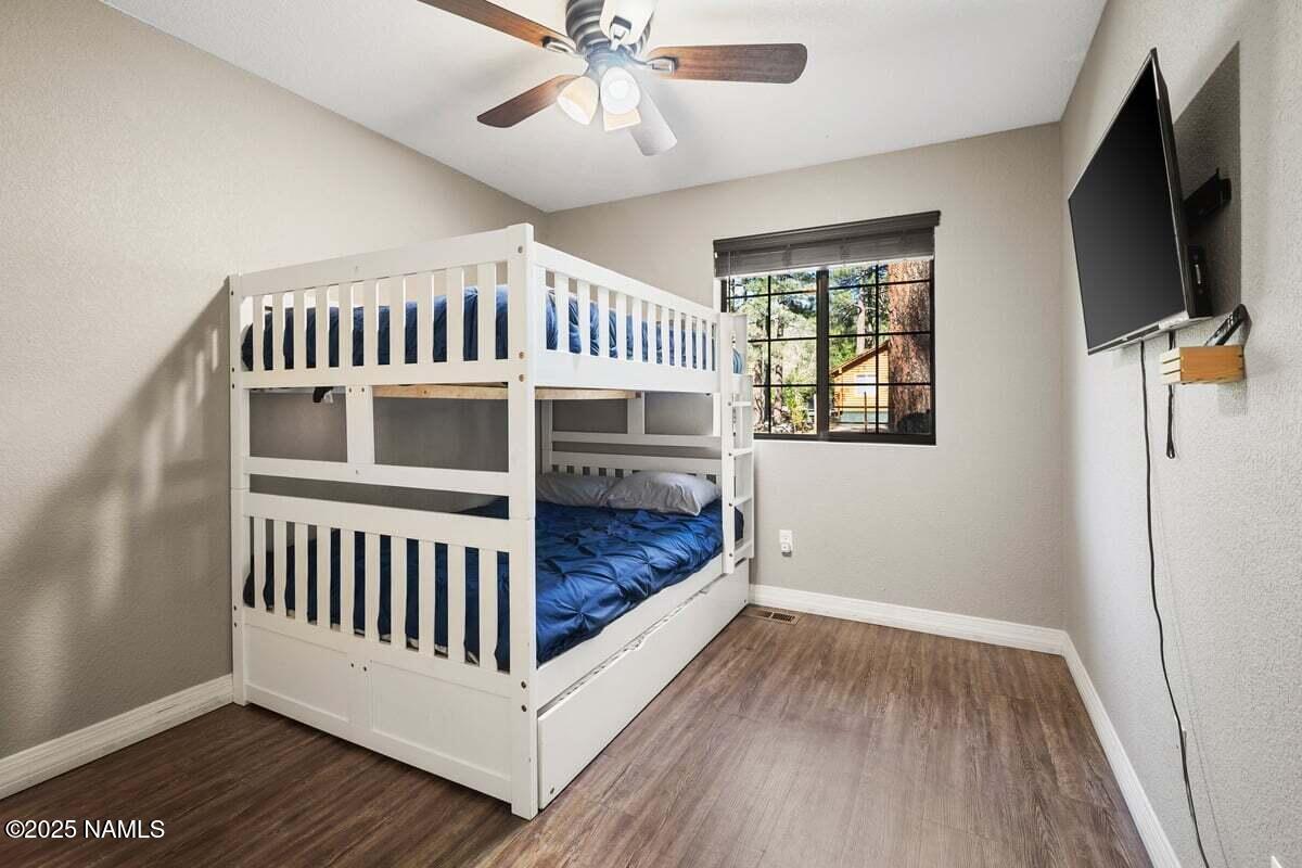 865 Caribou Road Munds Park, AZ 86017 - Photo 9 of 24 a view of hallway with wooden floor and chandelier