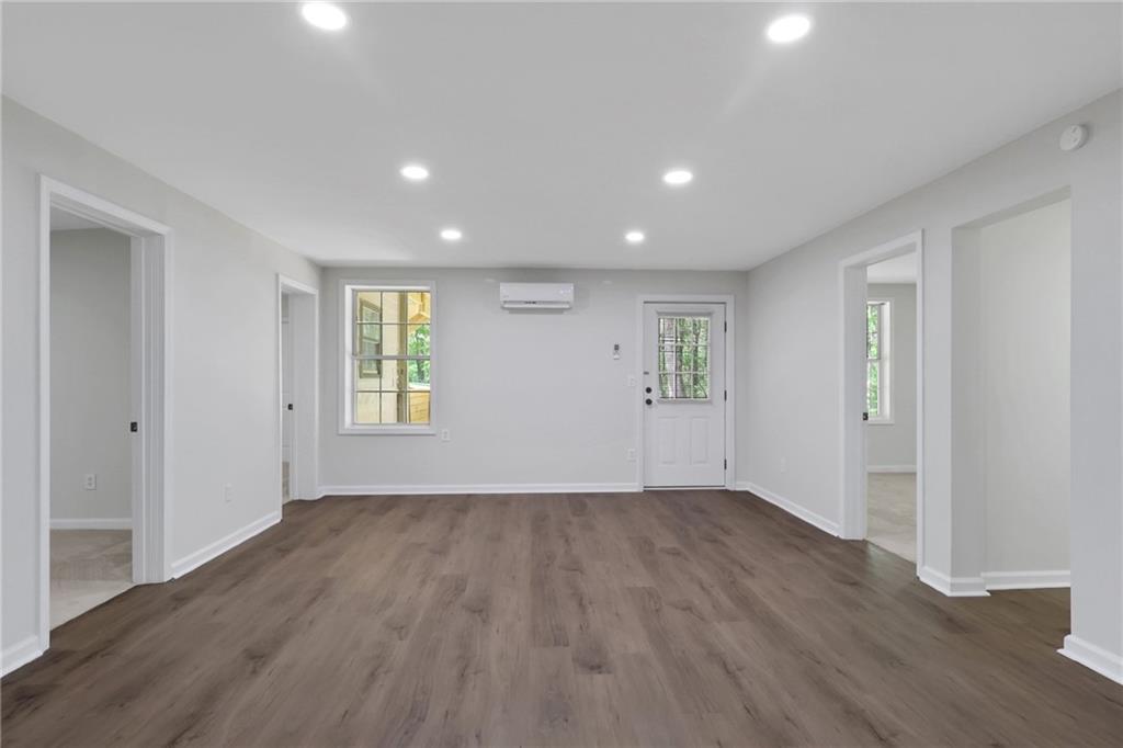 6259 Spring Lake Drive Flowery Branch, GA 30542 - Photo 17 of 35 a view of an empty room with wooden floor and a window