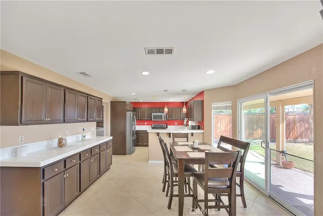 a open kitchen with stainless steel appliances granite countertop a sink dishwasher and cabinets with wooden floor