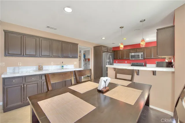 a kitchen with a sink a stove a refrigerator and cabinets