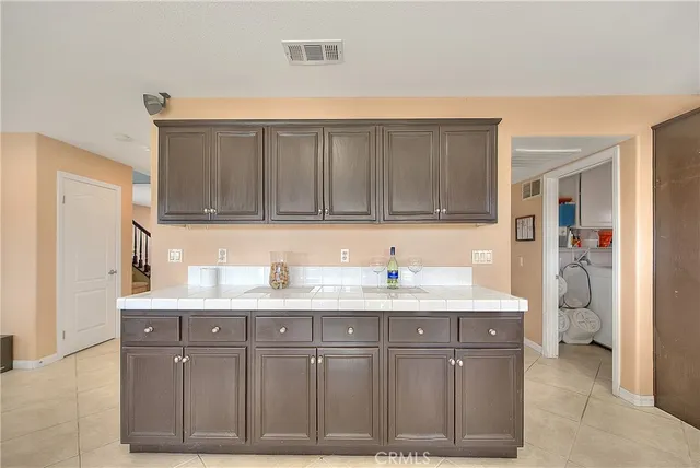 a kitchen with stainless steel appliances granite countertop a sink and a refrigerator