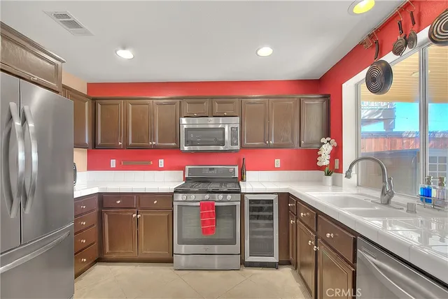 a kitchen with a sink cabinets and wooden floor