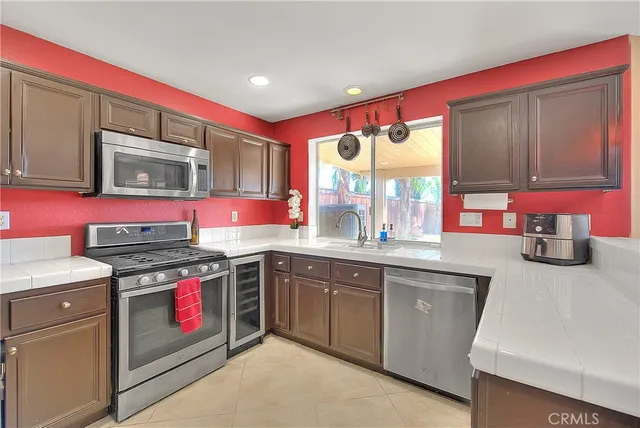 a kitchen with a sink cabinets and window
