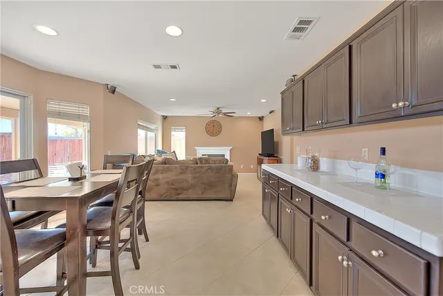 a living room with furniture and a dining table