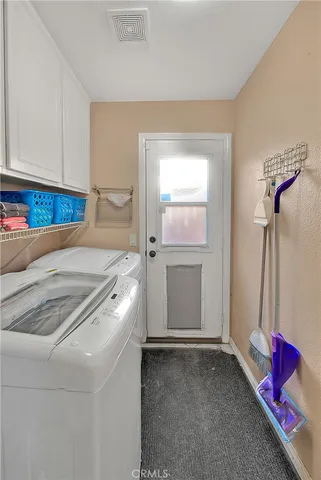 a view of staircase with lots of frames on wall and a window