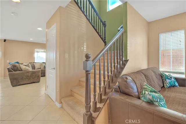 a view of a hallway with windows and stairs