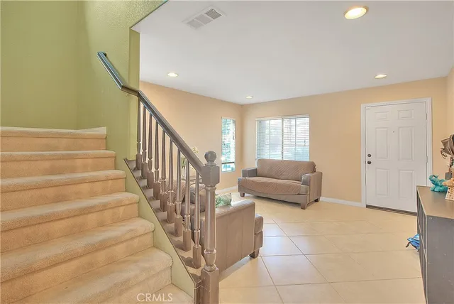 a living room with furniture and stairs