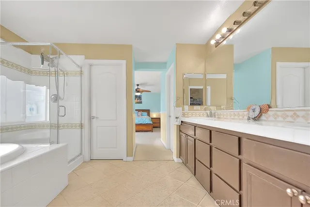 a living room with furniture and a baby crib