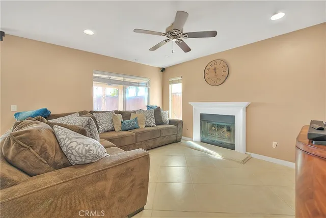 a living room with furniture a clock and a fireplace