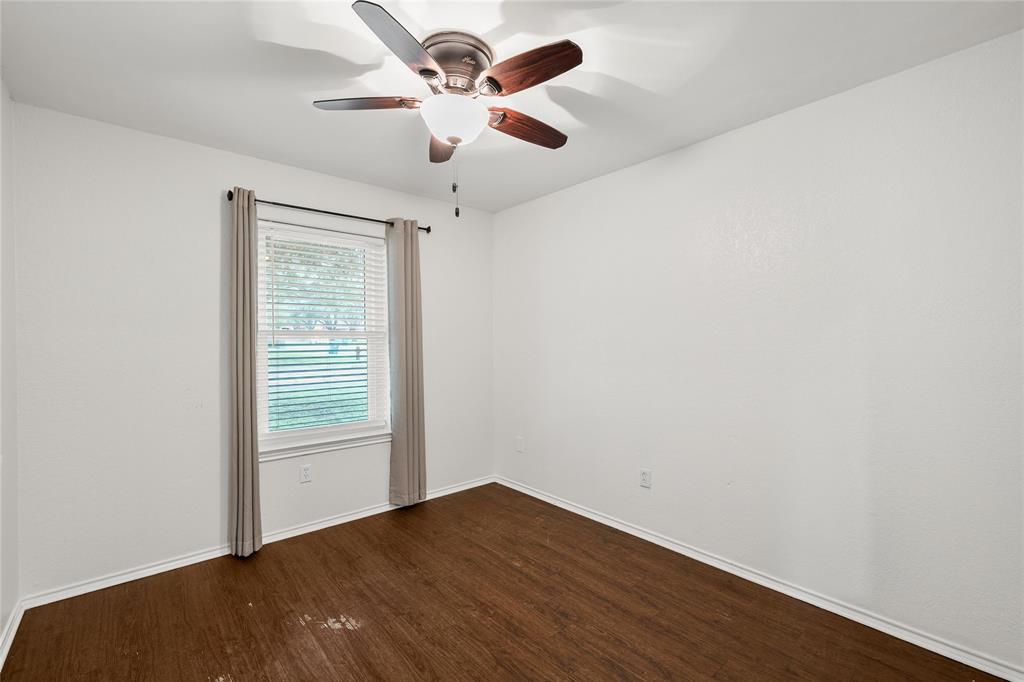 310 Ruth Drive Hewitt, TX 76643 - Photo 15 of 25 Bright room featuring wood-finish flooring, a window with blinds, and a ceiling fan with integrated lighting