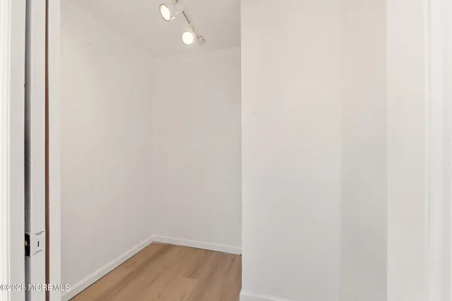 a view of a small space with wooden floor