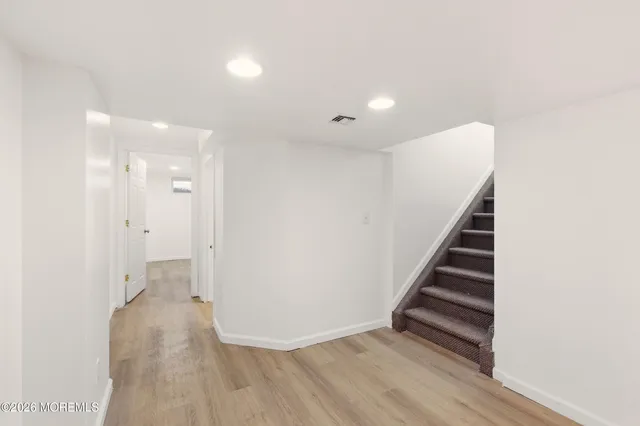 a view of an empty room with stairs and ventilation