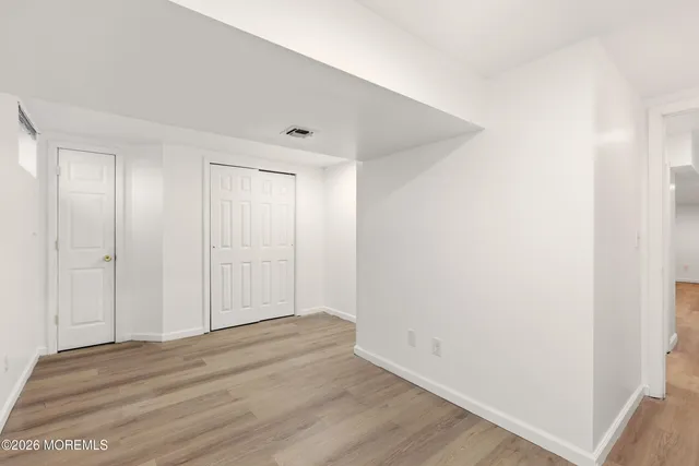 a view of room with wooden floor