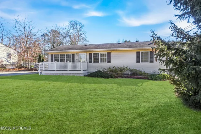a front view of house with yard and green space