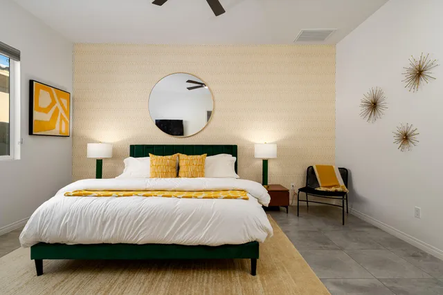 a bedroom with a bed and a lamp