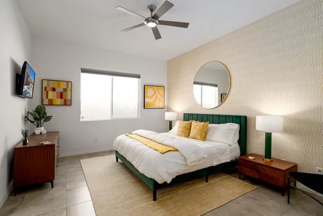 a bathroom with a granite countertop sink mirror and bathtub