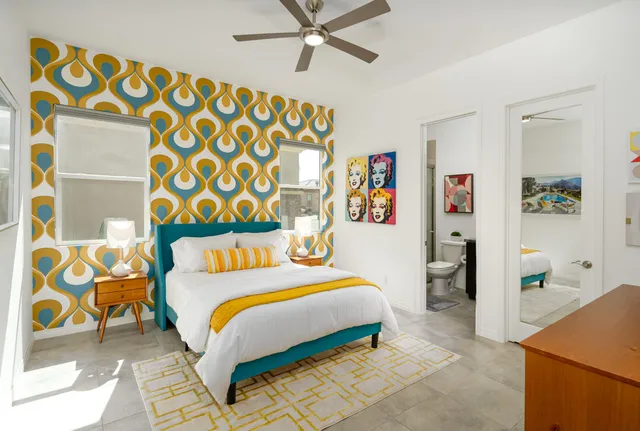 a bedroom with a bed and painting on the wall