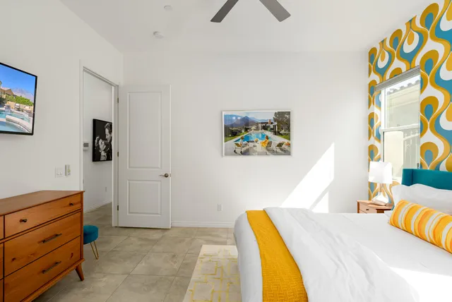 a bathroom with a granite countertop toilet sink and mirror