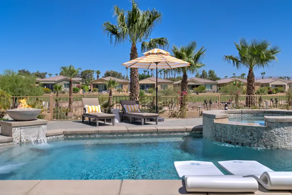 a swimming pool with outdoor seating and yard
