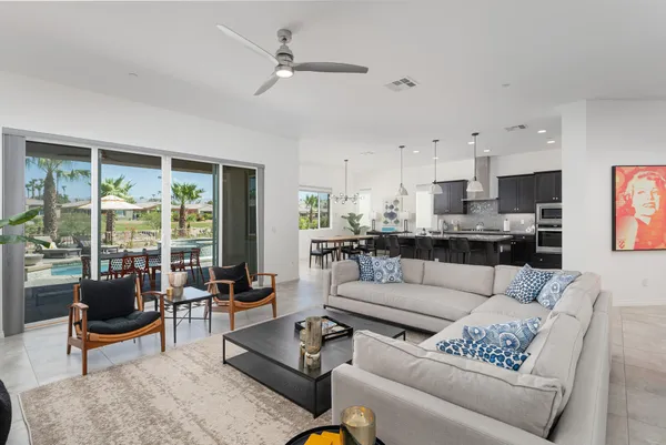 a living room with furniture kitchen view and a table