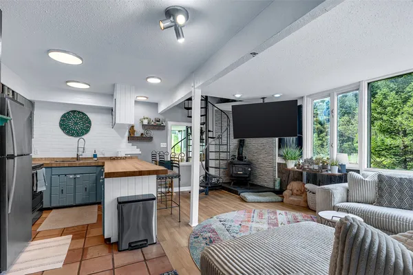 a living room with furniture a flat screen tv and a large window