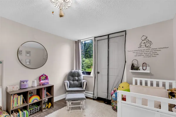a living room with baby crib furniture and a window