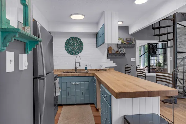 a kitchen with a sink a counter top space and cabinets