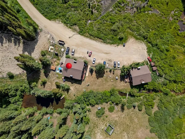 an aerial view of a house with a yard