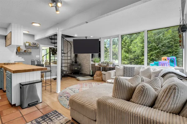 a living room with furniture and a floor to ceiling window