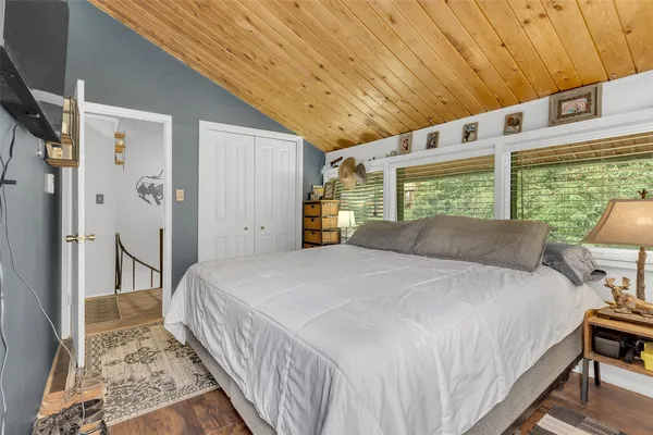 a large bed sitting in a bedroom next to a window