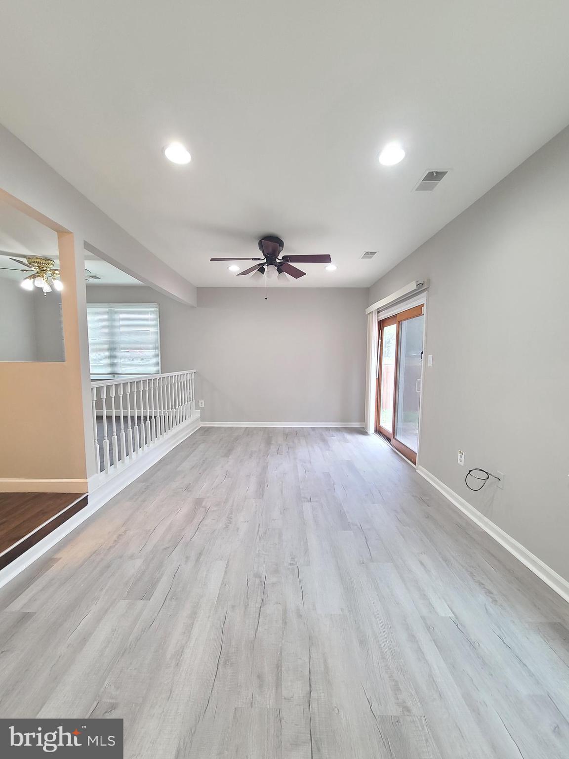 9050 Reynolds Place Manassas, VA 20110 - Photo 13 of 26 a view of an empty room with wooden floor and a window