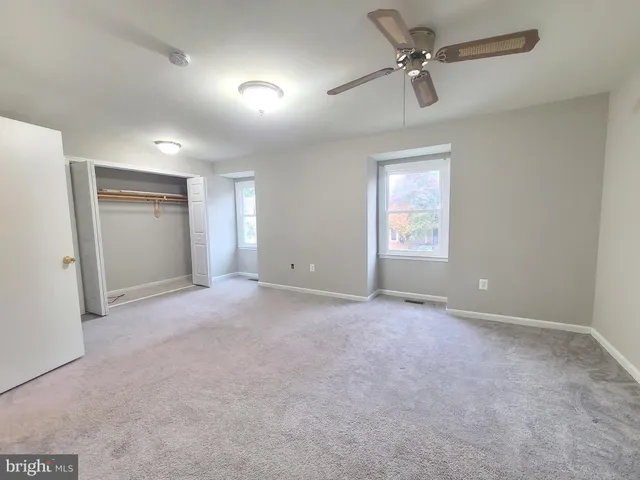 a view of a big room with windows and cabinet