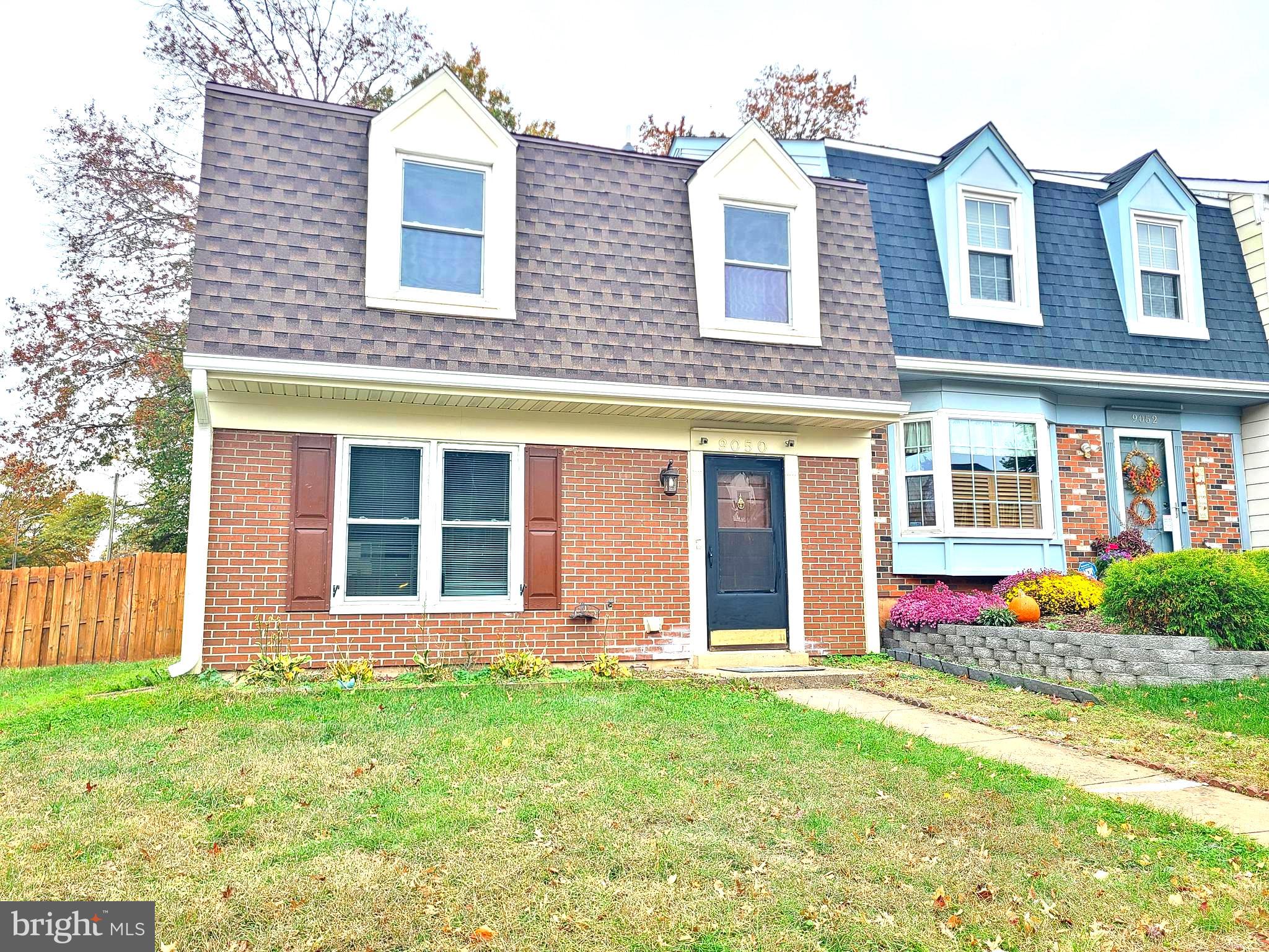 9050 Reynolds Place Manassas, VA 20110 - Photo 2 of 26 front view of a brick house with a yard