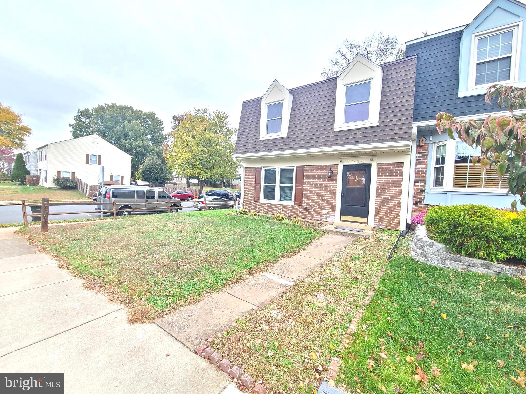 9050 Reynolds Place Manassas, VA 20110 - Photo 3 of 26 a front view of a house with a yard