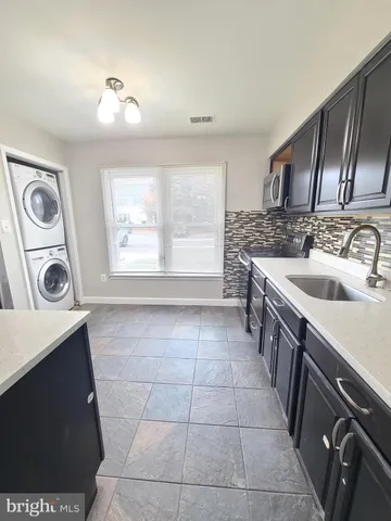 a view of a hallway with wooden floor and glass door