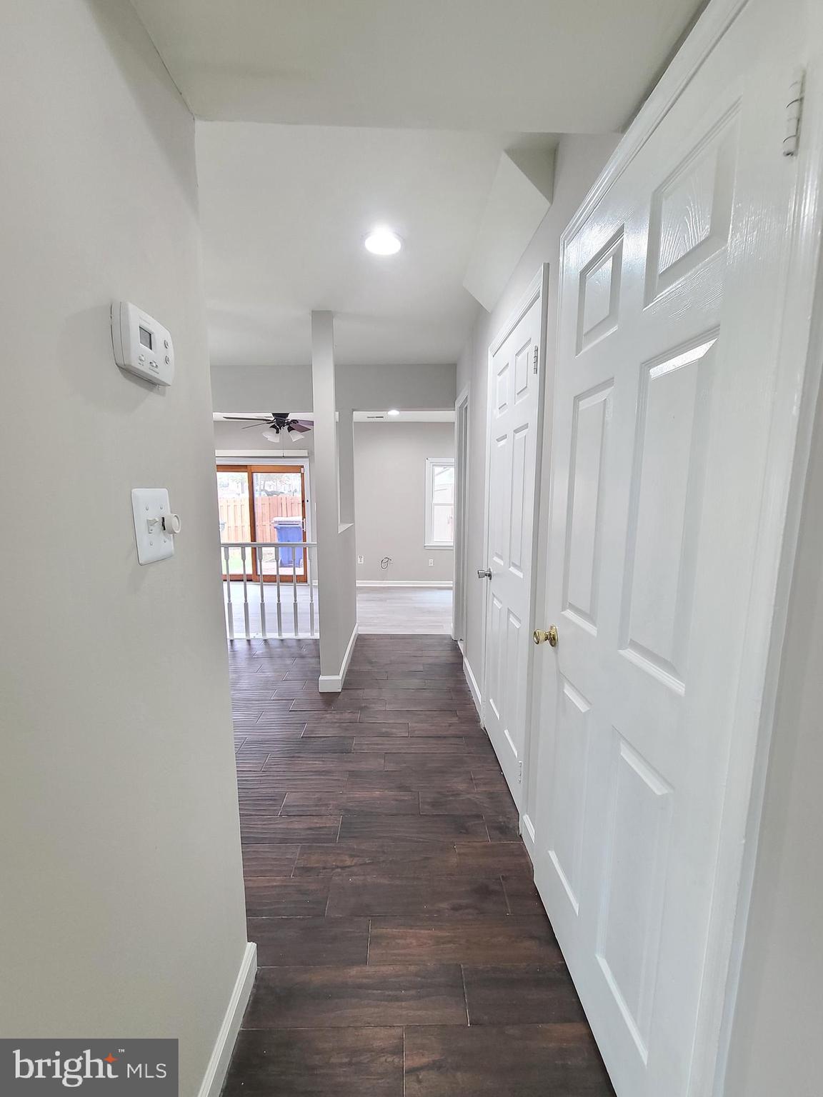 9050 Reynolds Place Manassas, VA 20110 - Photo 9 of 26 a view of a hallway with wooden floor and glass door