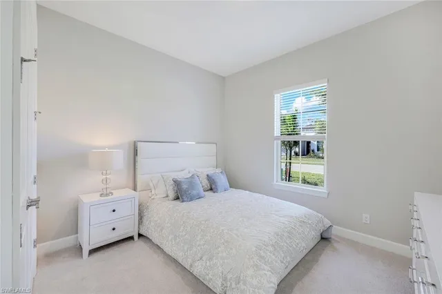 a large white bed in a white room