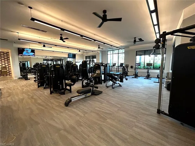 a kitchen with stainless steel appliances kitchen island granite countertop a sink and a stove