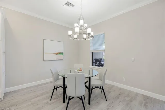 a view of a dining room with furniture and a chandelier