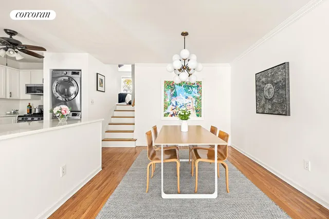 a dining room with wooden floor and breakfast area
