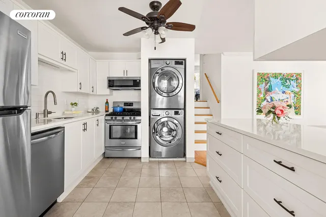 a kitchen with a stove top oven and cabinets