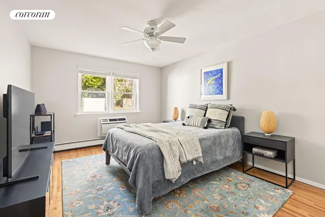 a bedroom with a bed and a tv on the dresser