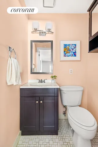a bathroom with a toilet a sink and mirror