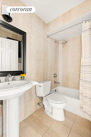 a bathroom with a sink a toilet and a mirror