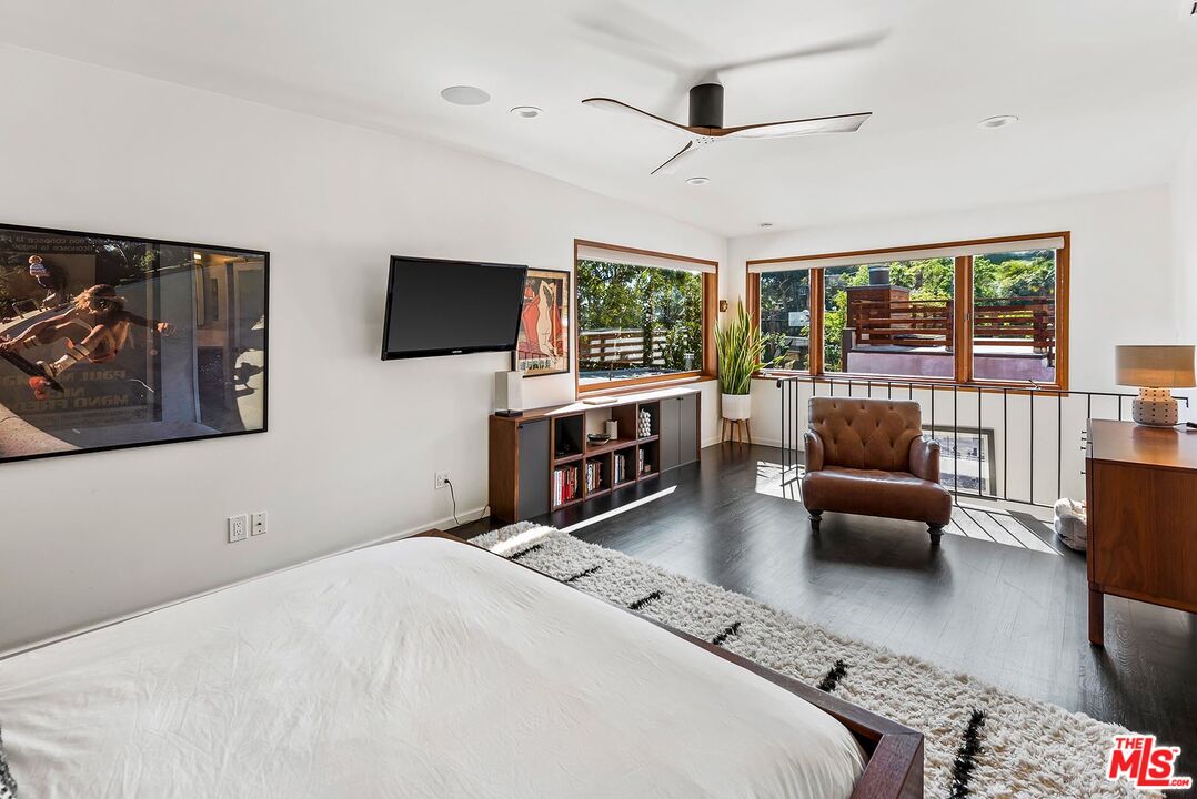8544 Ridpath Drive West Hollywood, CA 90046 - Photo 17 of 34 a bedroom with furniture and a flat screen tv