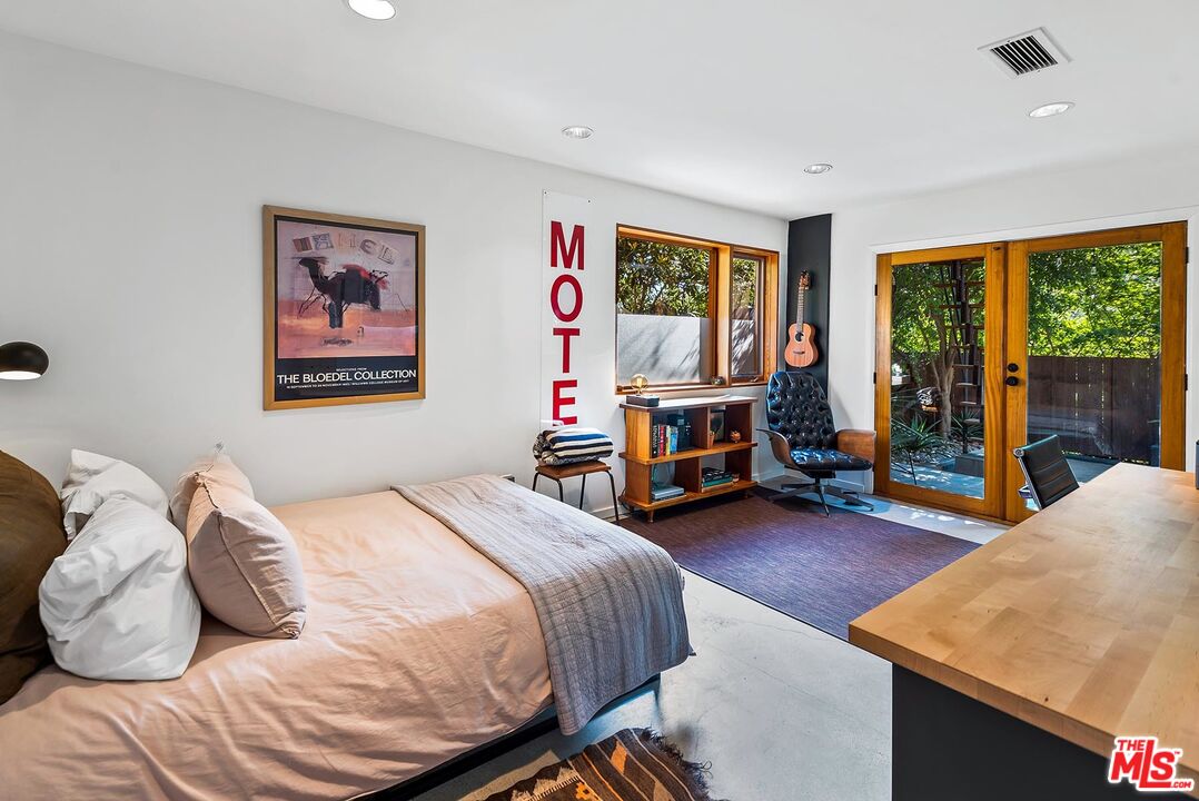 8544 Ridpath Drive West Hollywood, CA 90046 - Photo 23 of 34 a bedroom with a bed and a large window