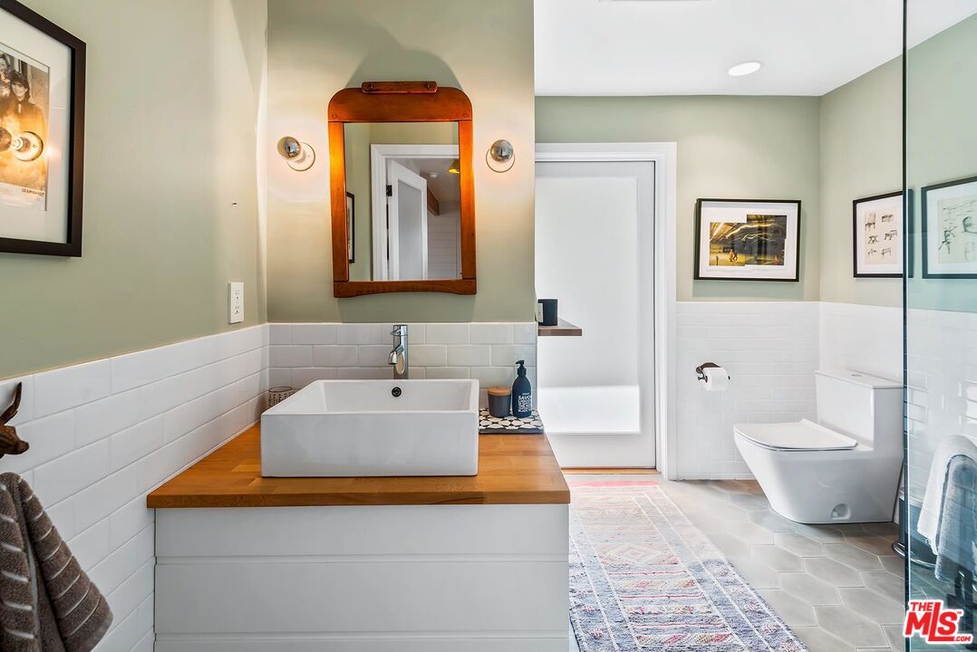 8544 Ridpath Drive West Hollywood, CA 90046 - Photo 25 of 34 a bathroom with a toilet sink and mirror